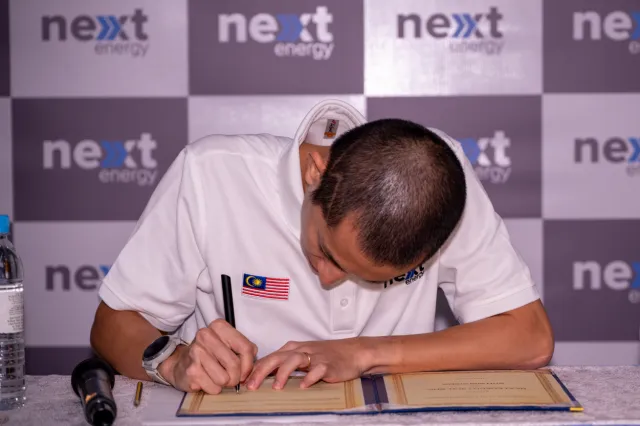 Soh Wai Ching signing the brand ambassador agreement with Next Energy