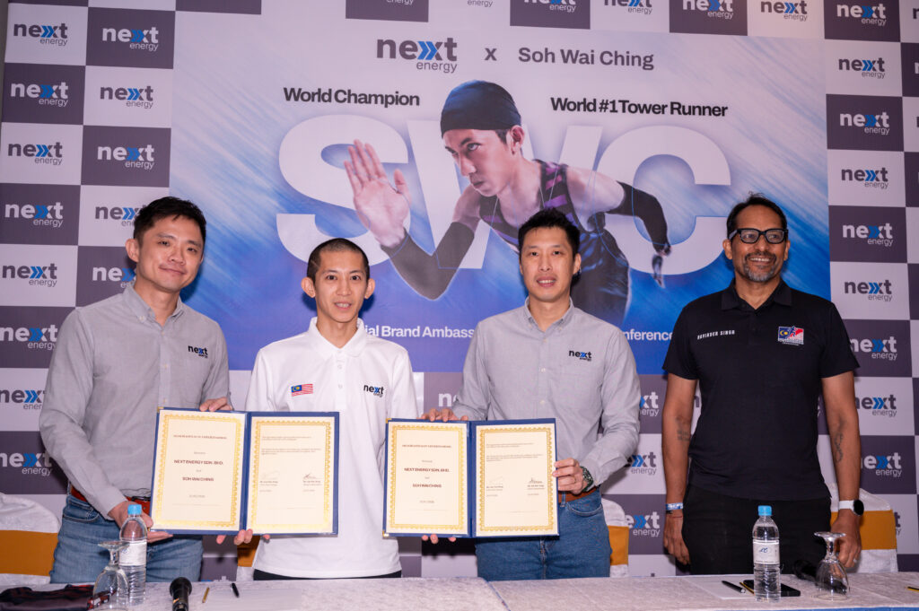 Soh Wai Ching and Next Energy representatives holding the signed brand ambassador agreements at the signing ceremony