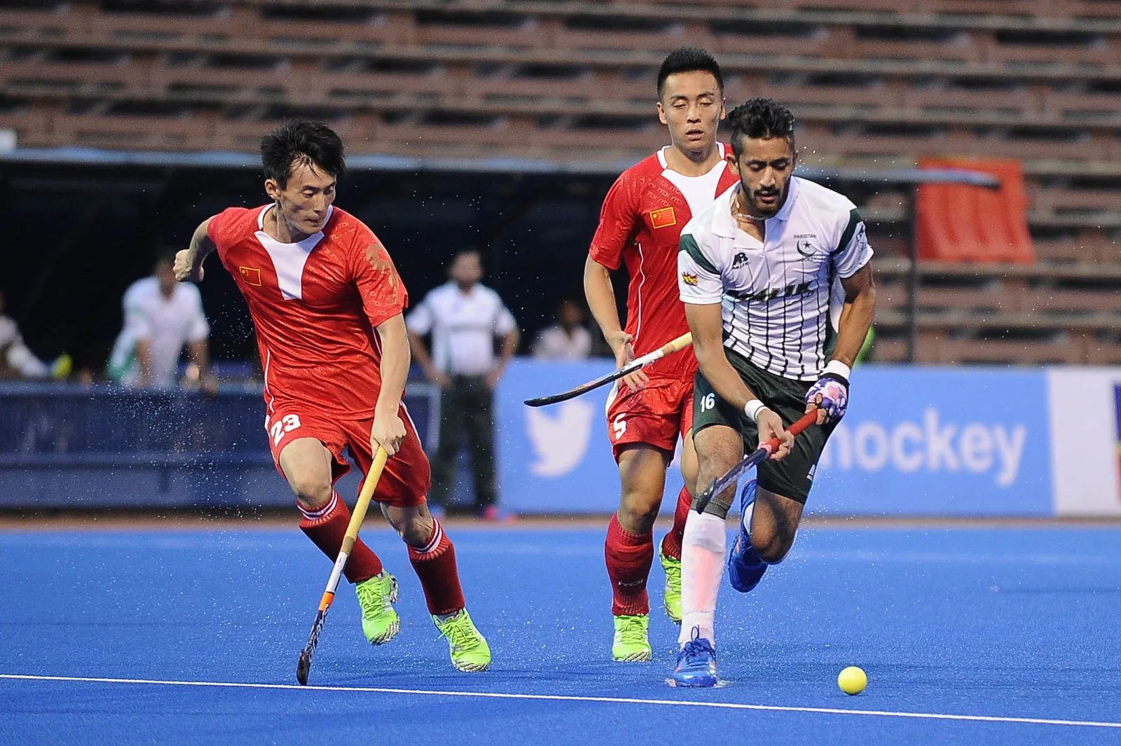 Pakistan's Ammad Shakeel Butt (left) dribbles the ball away from two Chinese players during their QNET 4th Men's Asian Champions Trophy 2016 match at the Wisma Belia Hockey Stadium, Kuantan today. Pakistan won 4-0.
